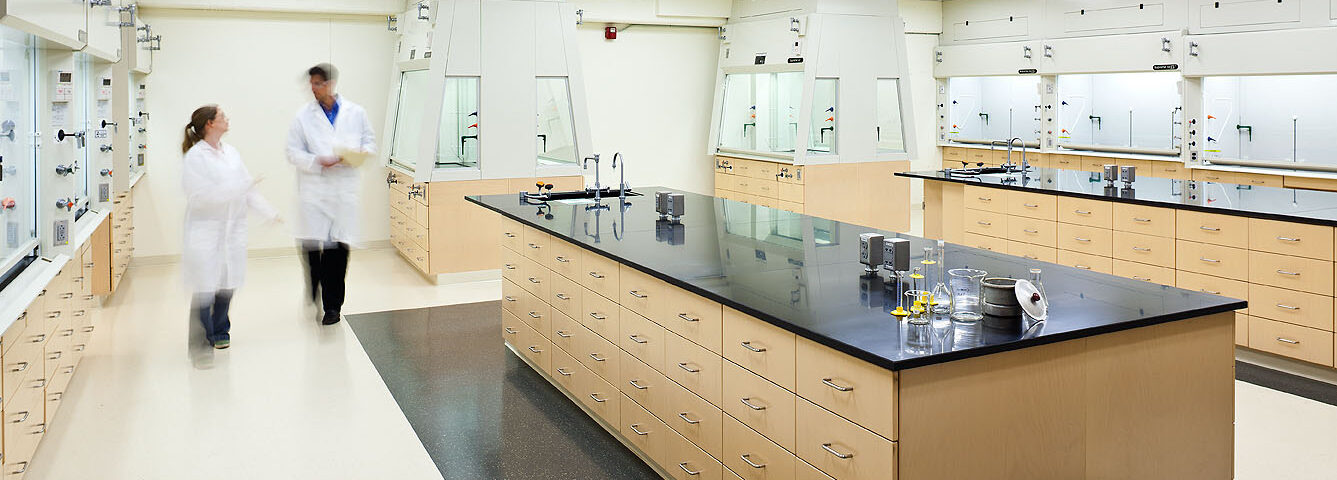 Portland State University teaching laboratory w/ male technician in lab coat.