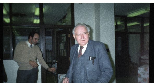 a man and woman walking in a hallway