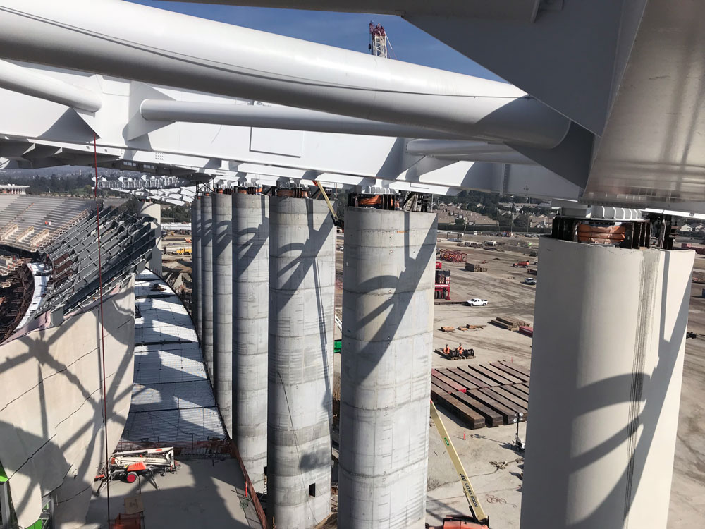 concrete columns and roof of a stadium under construction