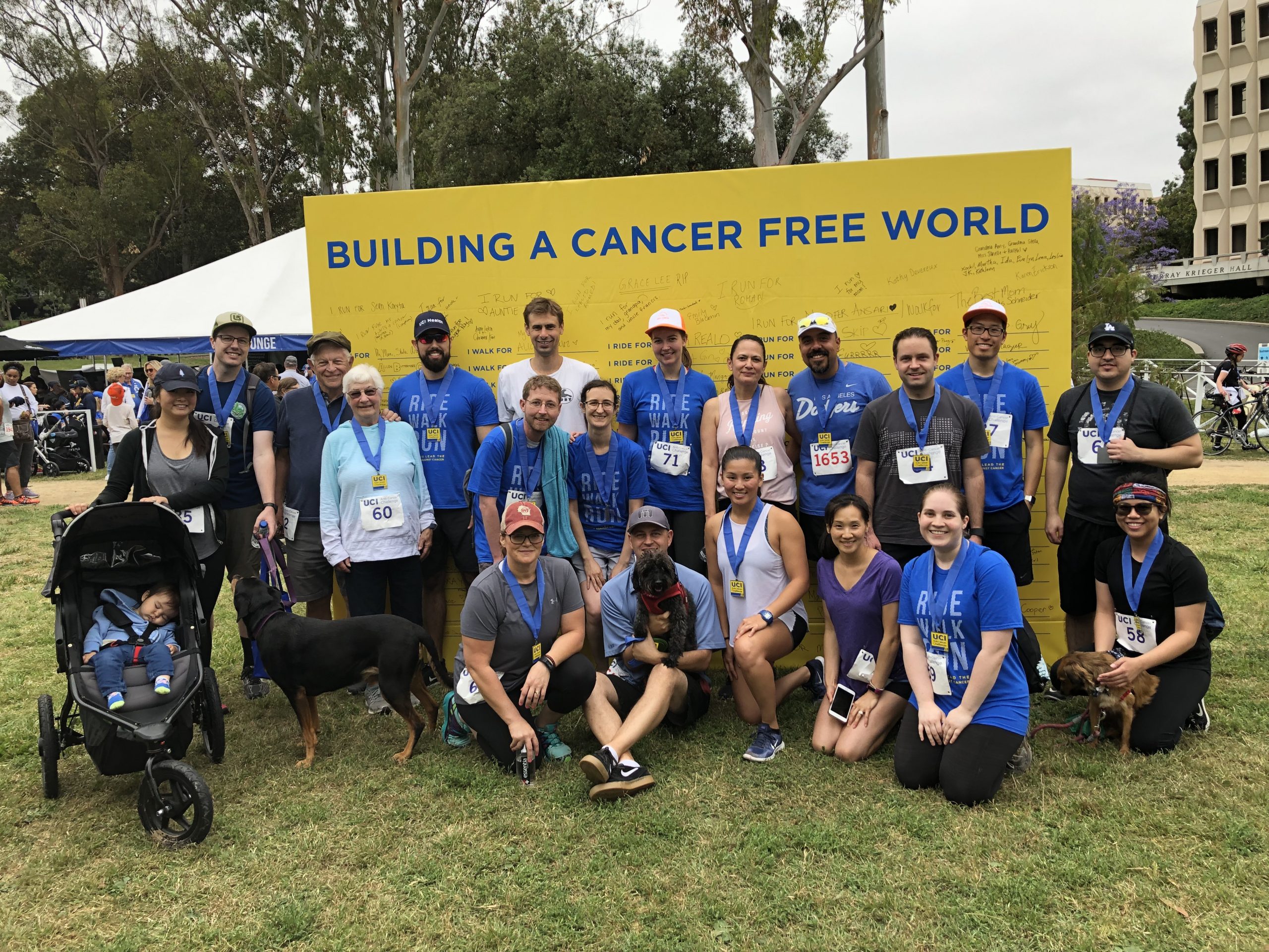 a group of people posing for a photo in front of a banner