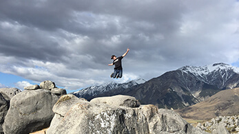 a person jumping on a rock