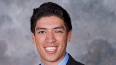 a man in a suit smiling