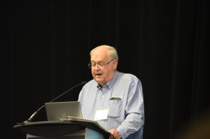 man speaking at podium